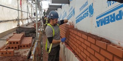 Bricklayer laying bricks